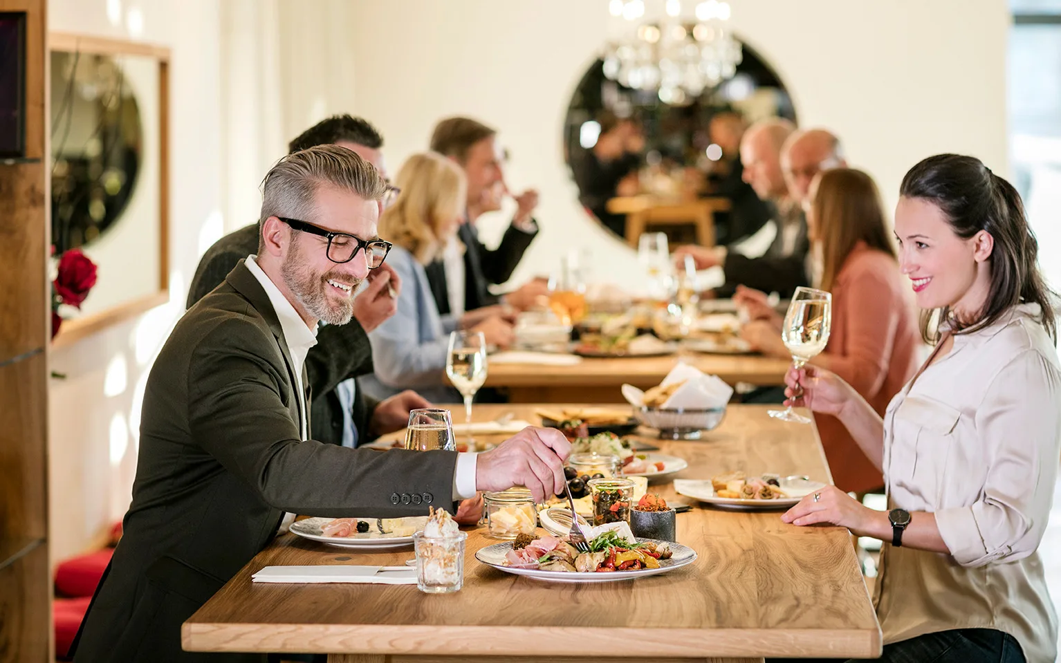 A group of people enjoying a meal together in a stylish restaurant.