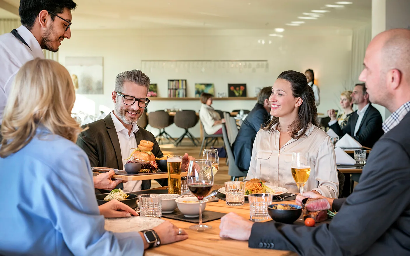 A group of guests enjoying an elegant dinner in a restaurant.