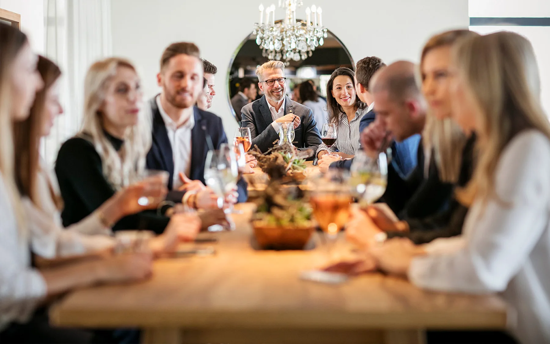 A group of people sitting at a table enjoying drinks.