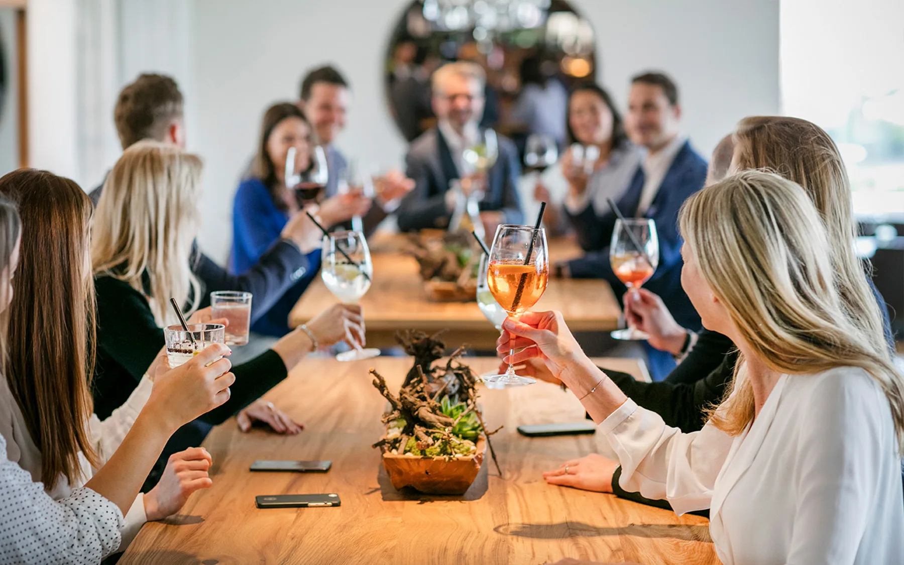 A group of people raising their glasses in a festive moment.